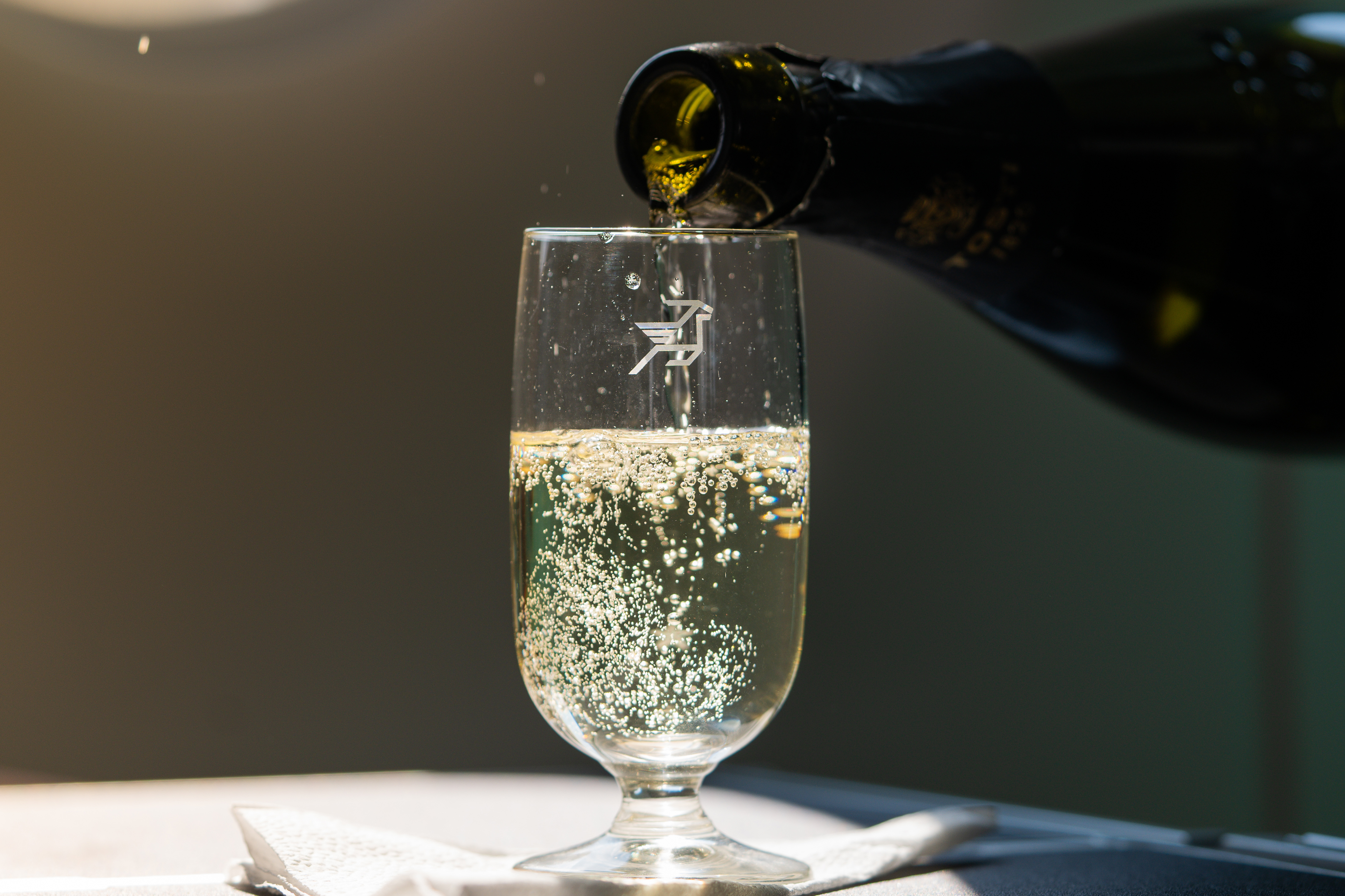 Glass of sparkling drink in Business Class